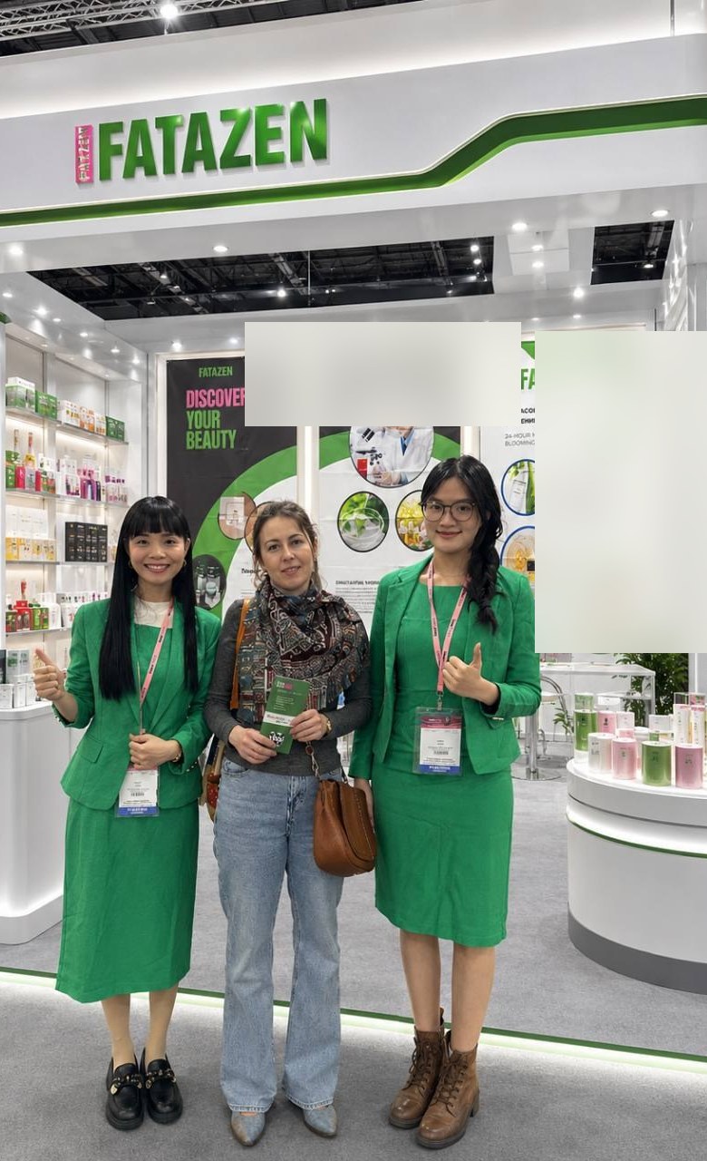FATAZEN team at a brand event booth with skincare display shelves