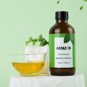FATAZEN Peppermint Massage and Aroma Oil bottle beside a glass bowl on a pale green background